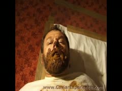 A sexy MILF wearing trousers and urinating on a hairy man's face